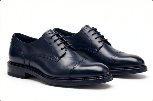 Navy blue leather derby shoes pair on white background
